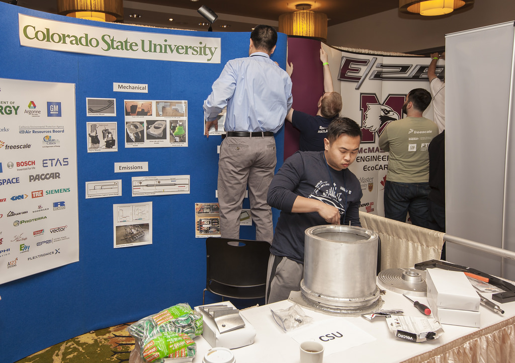 Two students at Colorado State University set up for a trade show.